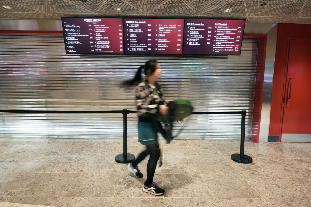 A staff member walks past a closed food concession stand at Kai Tak Stadium. Photo: Harvey Kong