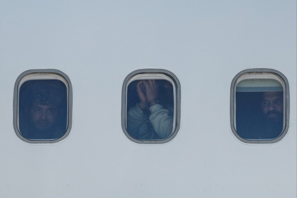 Venezuelan migrants deported from the US look out from an aircraft as they arrive in Maiquetia, Venezuela. Photo: Reuters