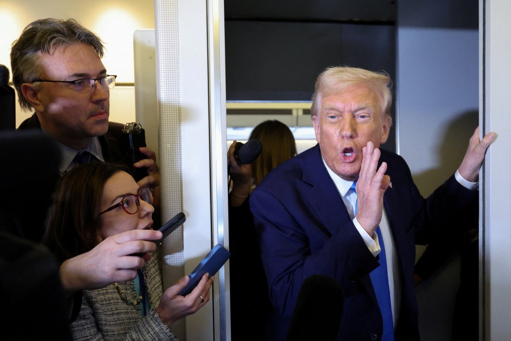 US President Donald Trump speaks to members of the media aboard Air Force One on Friday. Photo: Reuters