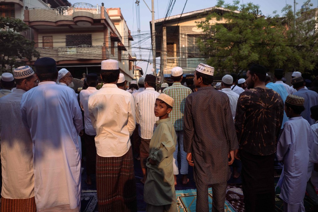 Muslims offer morning prayers to start the Eid ul-Fitr festival, marking the end of the holy fasting month of Ramadan, on a road near destroyed mosques in Mandalay, Myanmar, on Monday. Photo: AFP