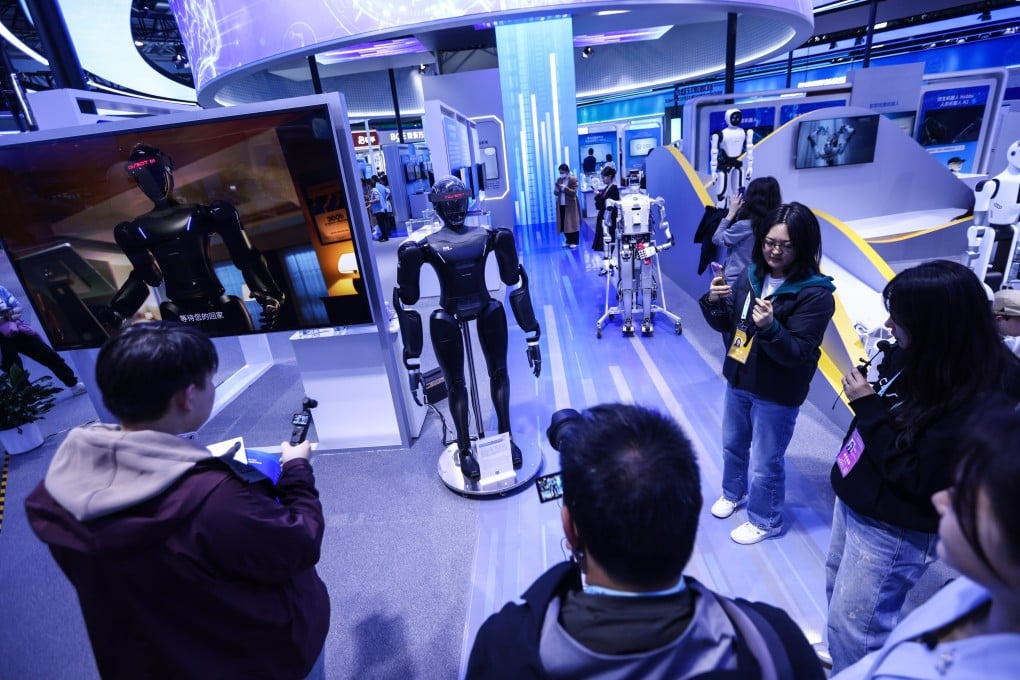 Visitors look at a humanoid robot during the 2025 Zhongguancun Forum in Beijing on Thursday. Photo: EPA-EFE