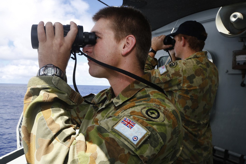Australian servicemen use binoculars to scan the ocean in 2014. Australian media described the Chinese vessel as a hi-tech research ship. Photo: Australian Defence Force/AFP