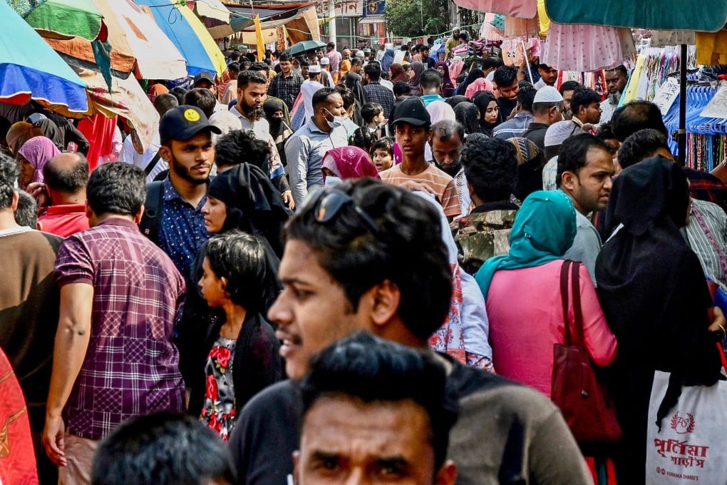 People buy clothes at a market in Dhaka. Bangladesh’s overseas workforce is estimated to be some 10 million strong. Photo: AFP