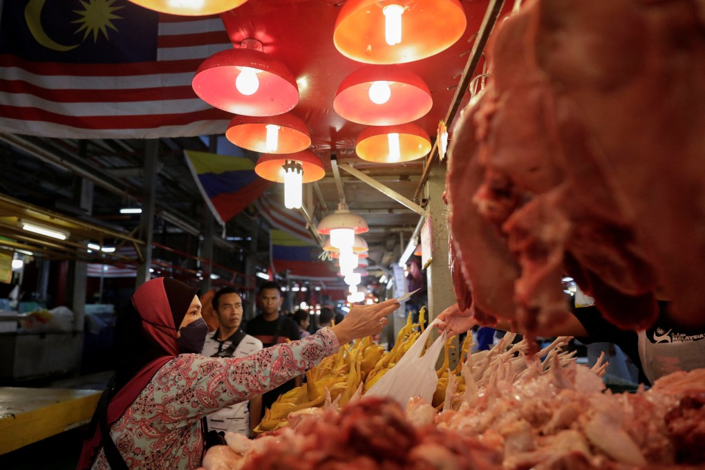 A woman shops at a wet market in Kuala Lumpur, Malaysia. Food prices rose 2.5 per cent in February, according to government data. Photo: Reuters