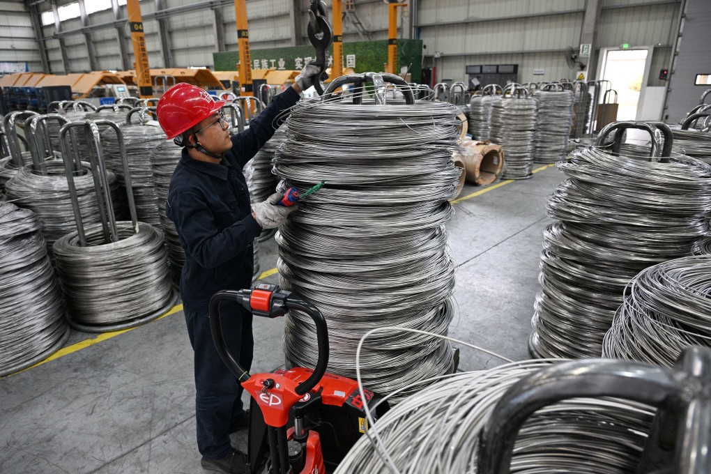 A worker moves welding wire at a factory in Taizhou, in Chinas eastern Jiangsu province, on March 27, 2025. Photo: AFP