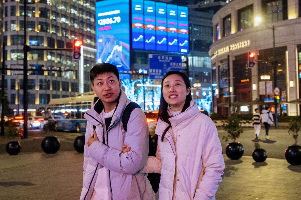 People walk in front of a large screen displaying stock data in Shanghai on March 11, 2025. Photo: EPA-EFE