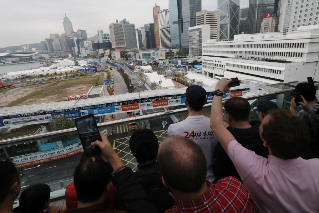 Spectators watch the Hong Kong ePrix, part of the Formula E Championship, from the IFC rooftop in Central. Photo: Felix Wong
