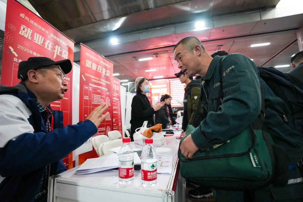 A job seeker from Sichuan province talks to a recruiter during a job fair at the Beijing West Railway Station on February 25. The fair is aimed at migrant workers who have just arrived in the city. Photo. Xinhua