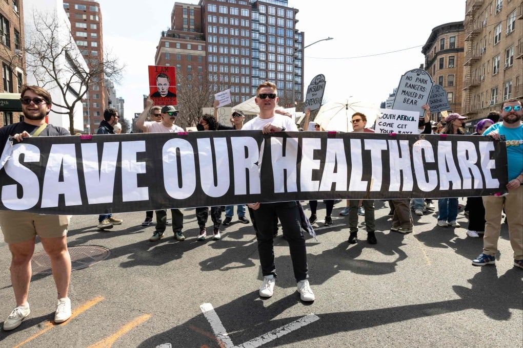 People march in protest against Tesla CEO Elon Musk and the Trump administration on March 29. Photo: AFP