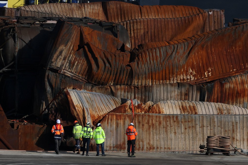 Salvage workers examine the container ship Solong, damaged after colliding with the anchored Stena Immaculate oil tanker, after it was towed into the port of Aberdeen in Scotland, UK on Friday. Photo: Reuters