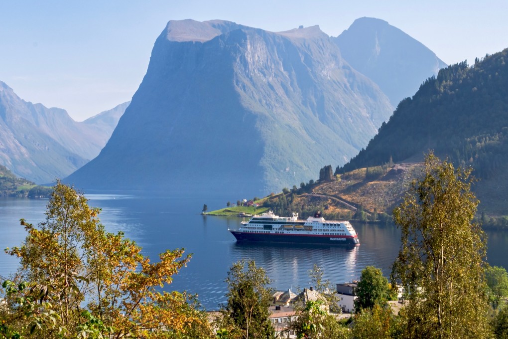 The MS Trollfjord in a Norwegian fiord surrounded by mountains. Hurtigruten cruises between Bergen and Svalbard in the Arctic Circle offer breathtaking scenery and never-ending sunlight. Photo: Shutterstock