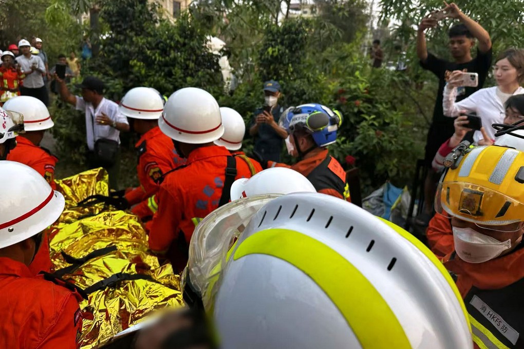 A Hong Kong rescue team carry a survivor away from the rubble of a Mandalay hotel in Myanmar. Photo: Handout