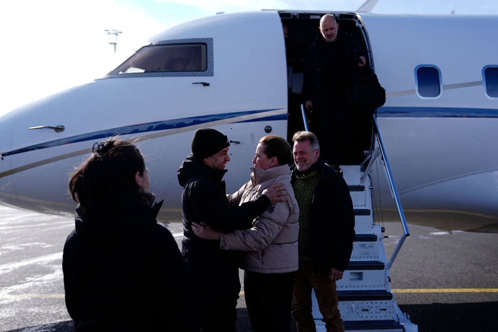 Denmark’s Prime Minister Mette Frederiksen (middle) and her husband Bo Tengberg (2nd from right) disembarks the aircraft and are greeted by Greenland’s acting Head of Government, Mute Bourup Egede at the Nuuk airport on Wednesday. Photo: AFP