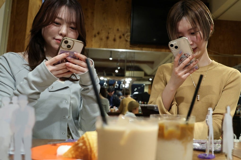 Momoka Matsui and her co-worker Saki Matsumoto at After All Coffee in Tokyo, where Matsui’s favourite boy band stopped by. They are taking part in “oshikatsu”, a fan-driven phenomenon in Japan that is boosting consumer spending. Photo: Reuters