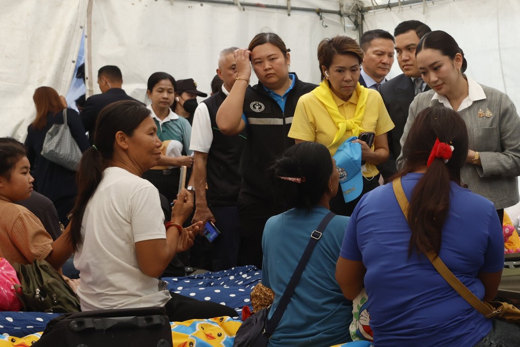 Thai Prime Minister Paetongtarn Shinawatra (right) visits relatives of a missing worker at the site of a building that collapsed following an earthquake in Bangkok on Wednesday. Photo: EPA-EFE