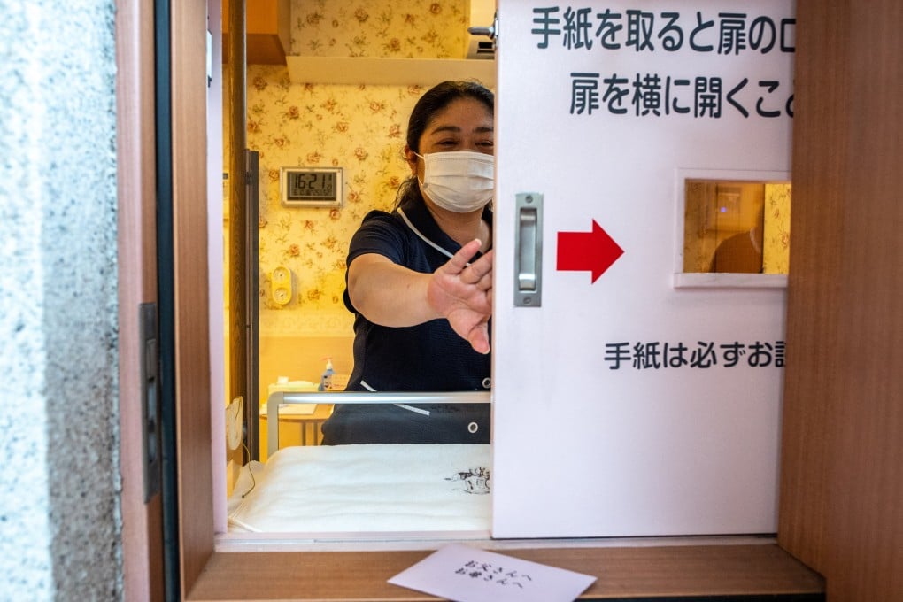 A member of staff demonstrates Japan’s first baby hatch at Jikei Hospital in Kumamoto city. Photo: AFP