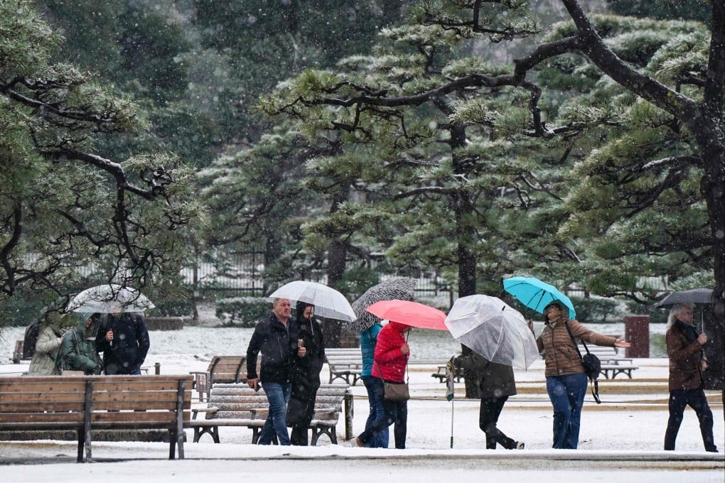 Tourists visit a park in front of the Imperial Palace in Tokyo. Photo: AFP
