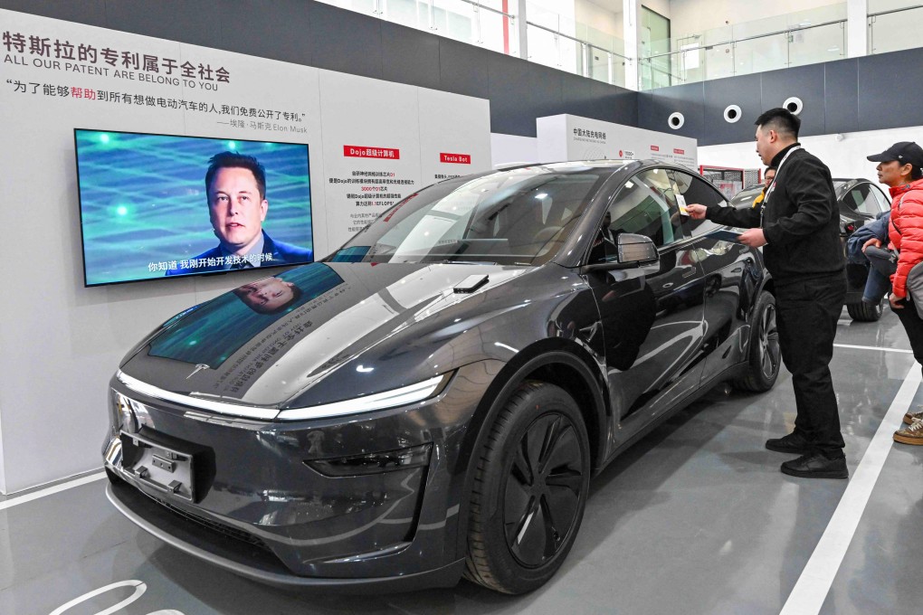 Customers check a Tesla Model Y car at the company’s delivery centre in Beijing. Photo: AFP