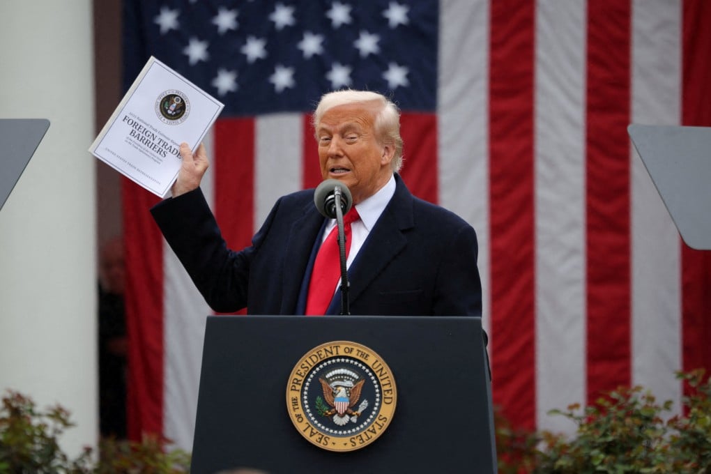 US President Donald Trump holds a “Foreign Trade Barriers” document as he delivers remarks on tariffs in the Rose Garden at the White House. Photo: Reuters