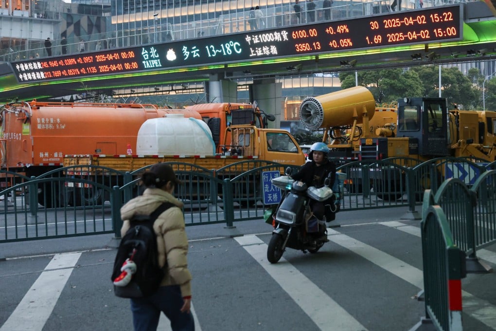 An electronic board shows stock indexes at the Lujiazui financial district in Shanghai on April 2. Photo: Reuters