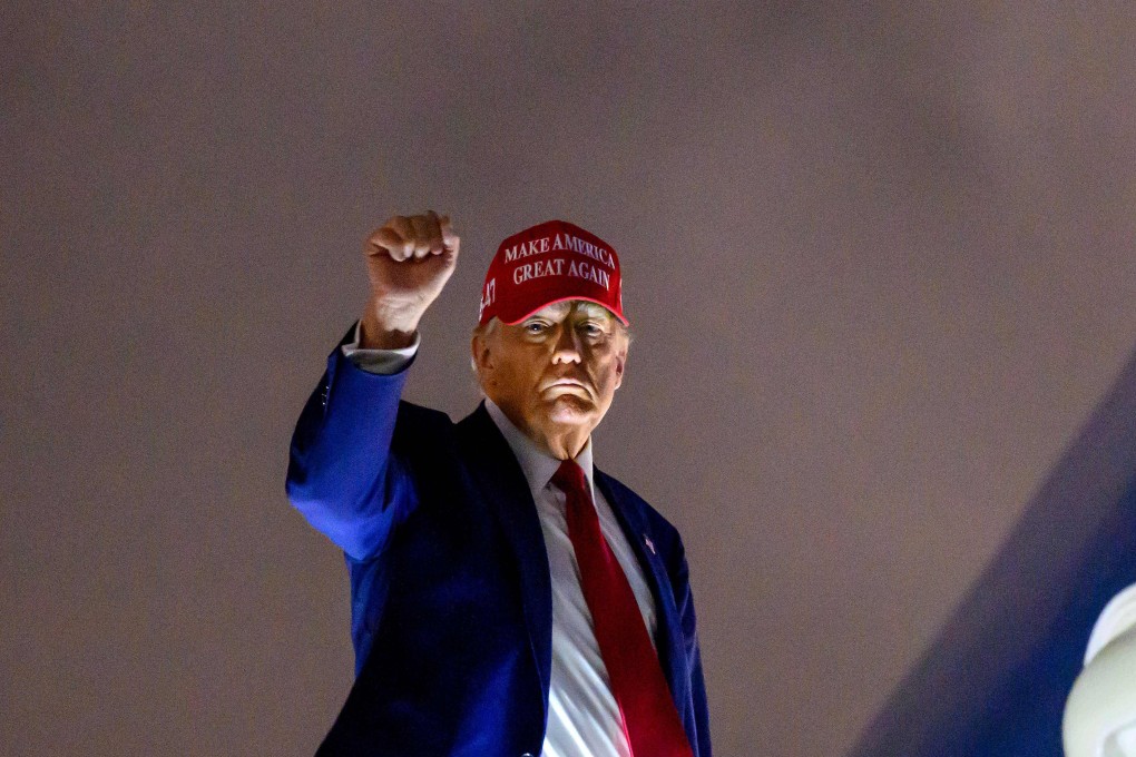 US President Donald Trump pumps his fist as he boards Air Force One on Thursday. Photo: AFP