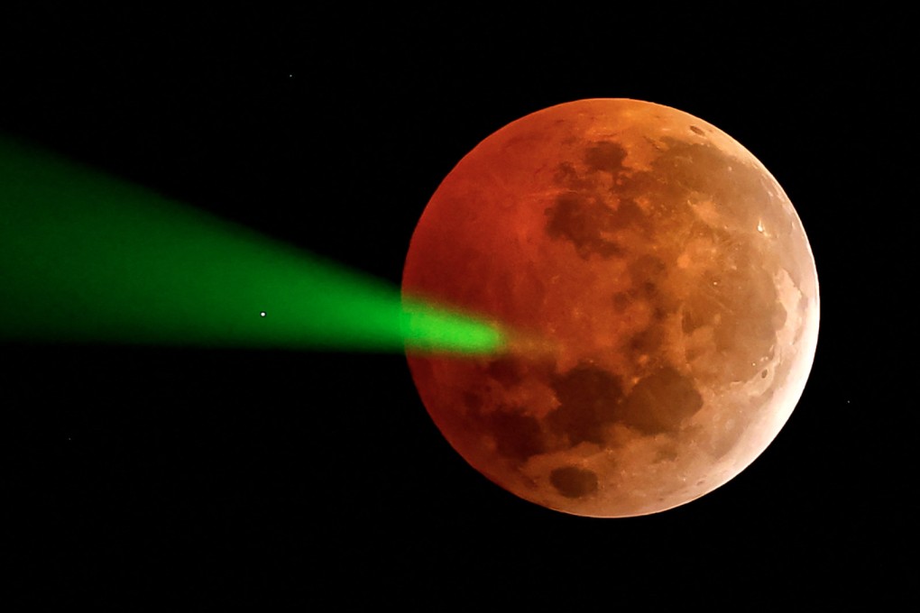 The full moon eclipse targeted with a laser from the Foster Observatory telescope in Santiago, Chile, on March 14. File photo: AFP