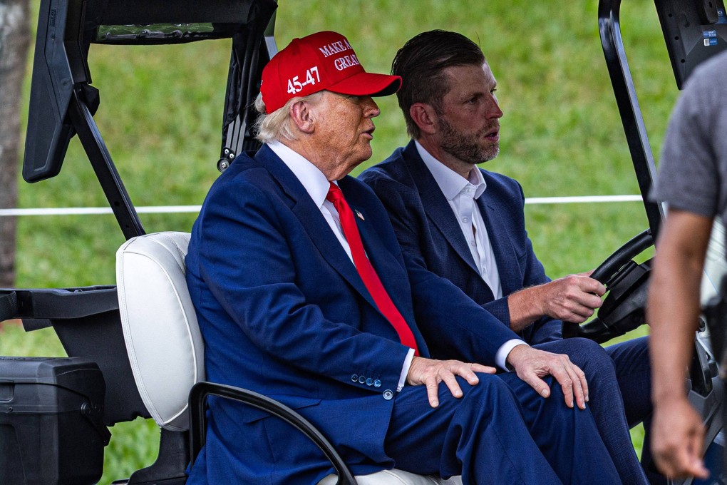 US President Donald Trump and his son Eric Trump drive in a golf cart at Trump National Doral Miami golf course in Doral, Florida on Thursday. Photo: AFP