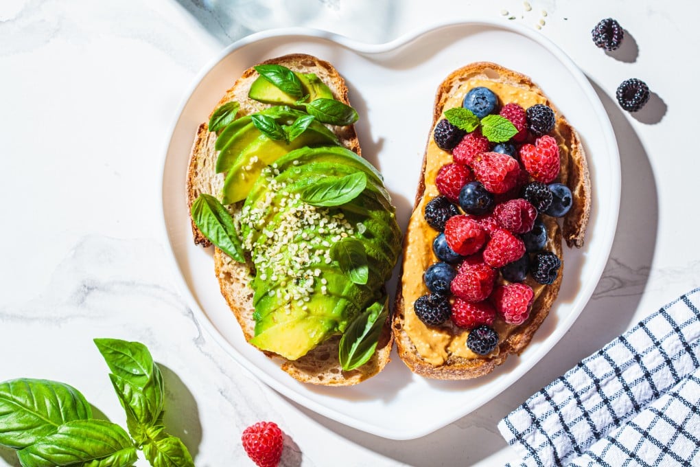 Avocado toast with basil, and peanut butter and berries toast contain several of the ingredients nutrition experts include in their healthy breakfasts. Photo: Shutterstock