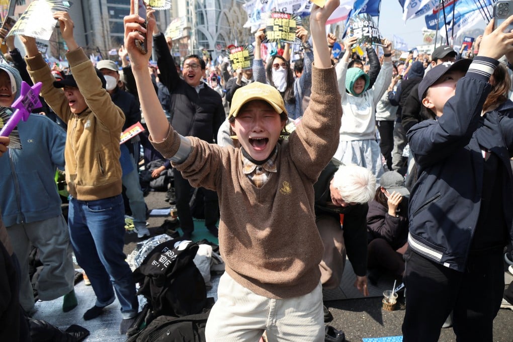 South Koreans celebrate after Yoon Suk-yeol was removed from office on Friday. Photo: Reuters