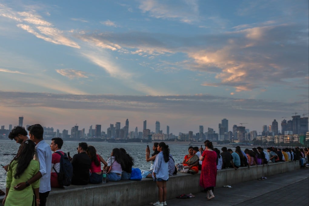 People enjoy the sunset along the Marine Drive promenade, one of the famous sunset spots near the Arabian Sea shore in Mumbai, India, on March 17. This year’s World Happiness Report places India at 118, behind Iran at 99, Palestine at 108 and Ukraine at 111. Photo: EPA-EFE