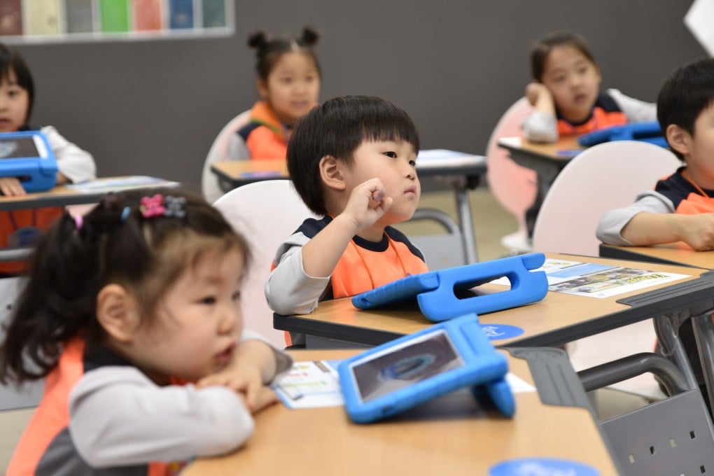 Kindergarteners listen to their teacher read a story in Seoul. South Korea’s current education system teaches children to ruthlessly compete against one another. Photo: Shutterstock
