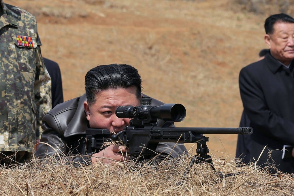 North Korea’s leader Kim Jong-un looks through a rifle scope as he visits a training base of the Korean People’s Army’s special operations forces. Photo: KCNA/KNS/AFP