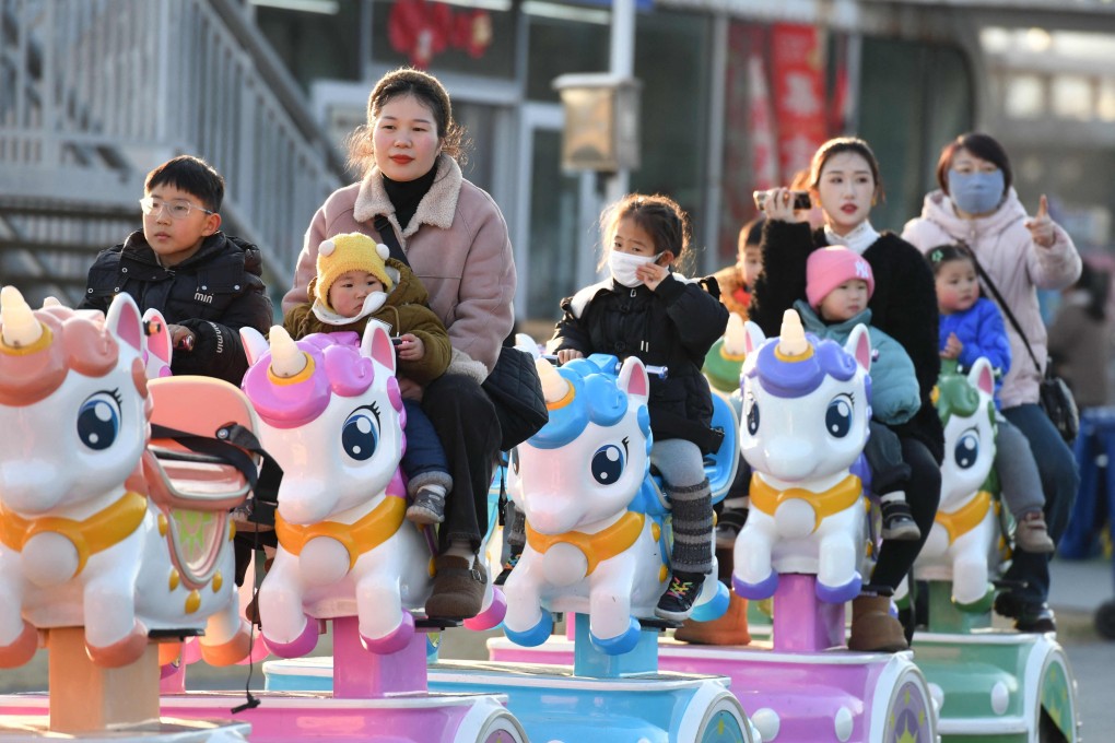 Children take a ride with adults at a park in Fuyang, Anhui province. Nearly one third of Chinese children aged over seven could be overweight or obese by 2030, according to the National Health Commission. Photo: AFP