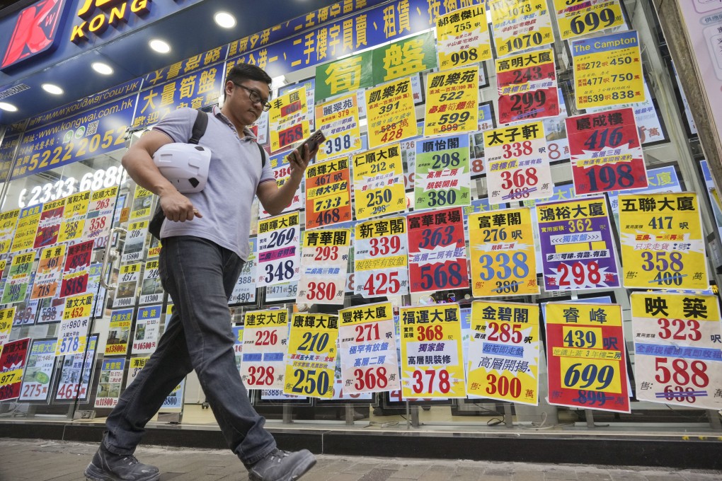 A man passes a property agency in Cheung Sha Wan. Photo: May Tse