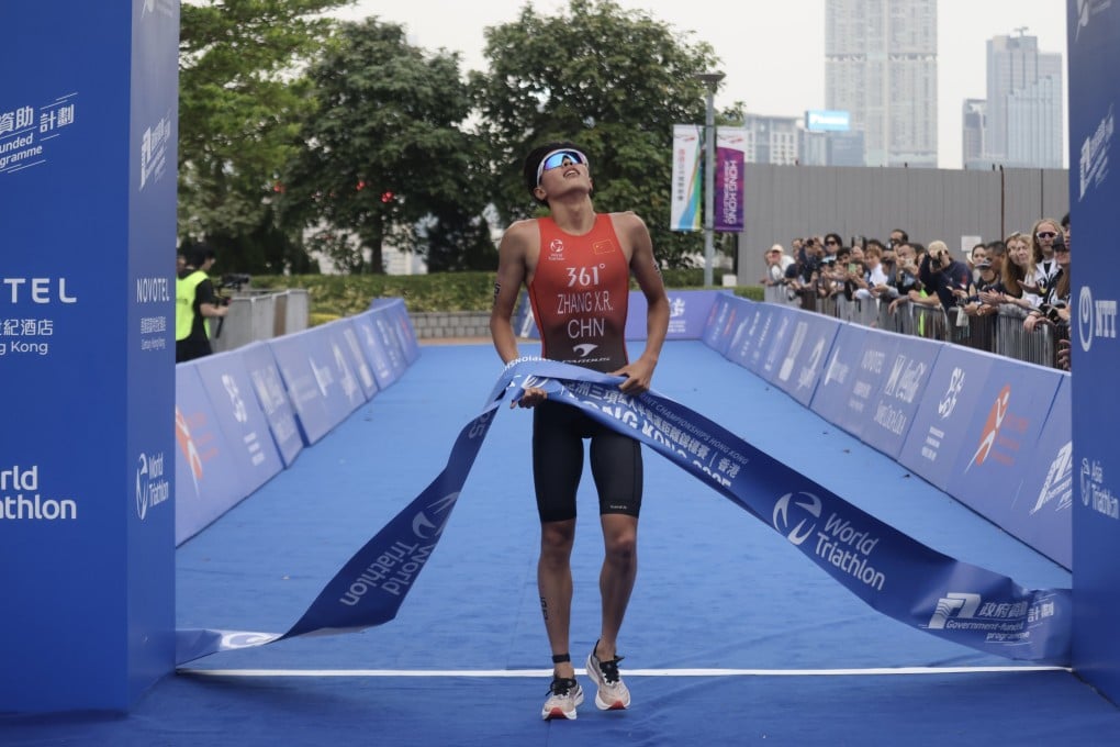 Zhang Xirui crosses the finish line to claim gold for Team China in the relay event at the Asia Triathlon Sprint Championships . Photo: Jonathan Wong