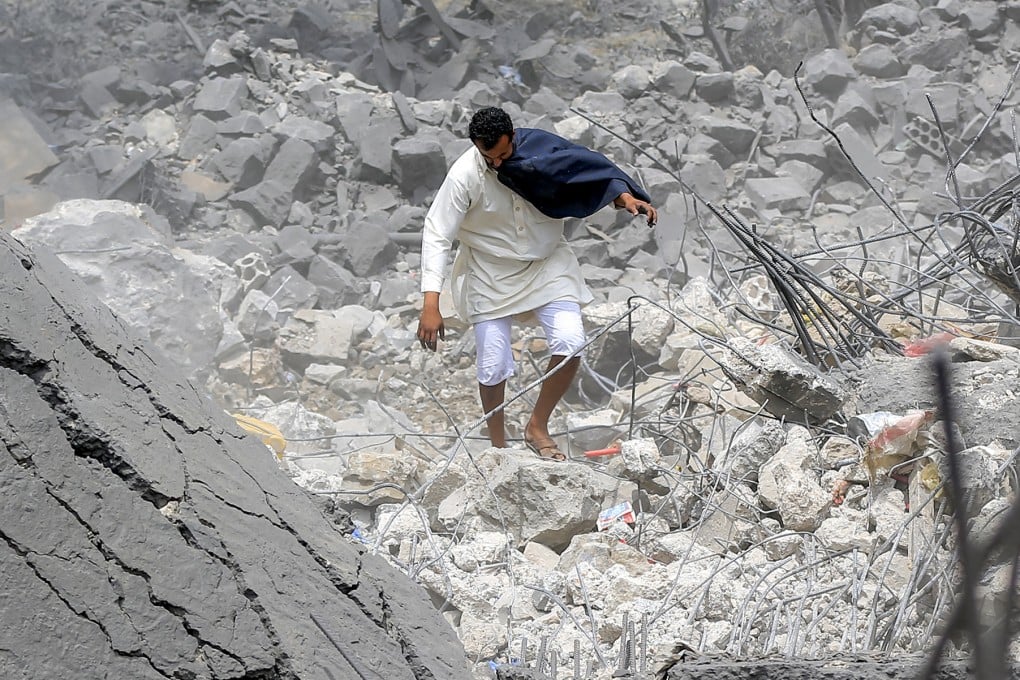 A man walks through the rubble of a collapsed building at the site of a reported US air strike in Yemen’s Houthi-held capital Sanaa last month. Photo: Getty Images/TNS/AFP