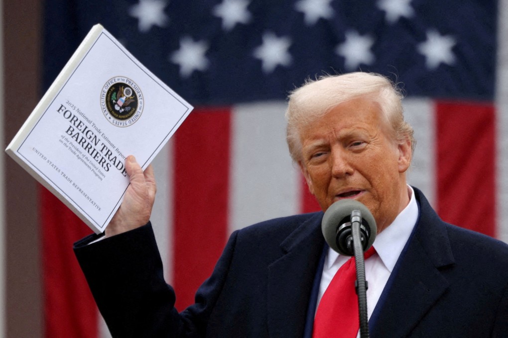 US President Donald Trump holds a “Foreign Trade Barriers” document as he delivers remarks on tariffs in the Rose Garden at the White House. Photo: Reuters