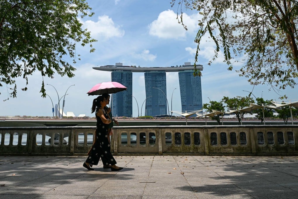 People walk along Queen Elizabeth Walk in Singapore. The city state is subject to the minimum 10 per cent universal tariff on all exports to the US. Photo: AFP