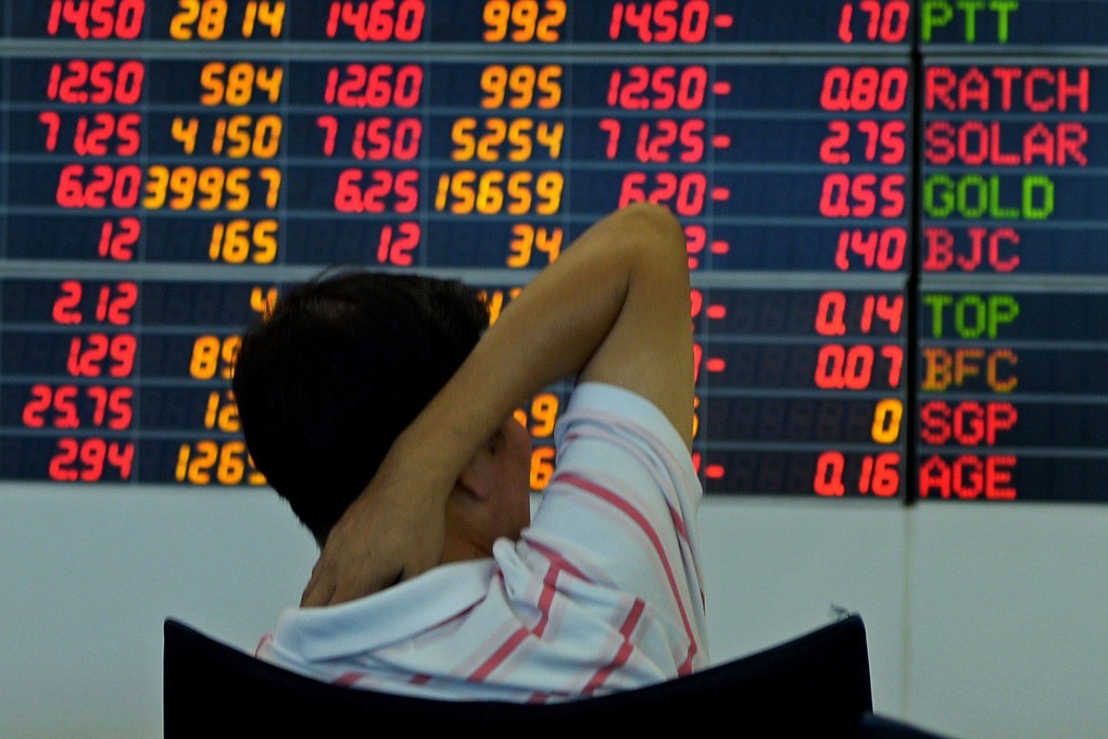 A Thai investor looks at an electronic display of share prices in Bangkok. Thailand has banned short selling to stabilise the stock market following US tariffs. Photo: AFP