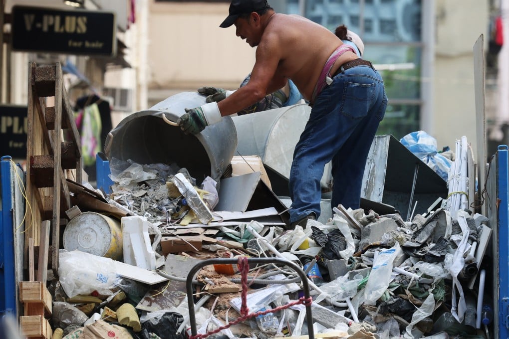 A worker moves renovation waste onto a lorry in the neighbourhood of Jordan on June 26. Green design in Hong Kong should involve reusing salvaged materials. Photo: Jelly Tse