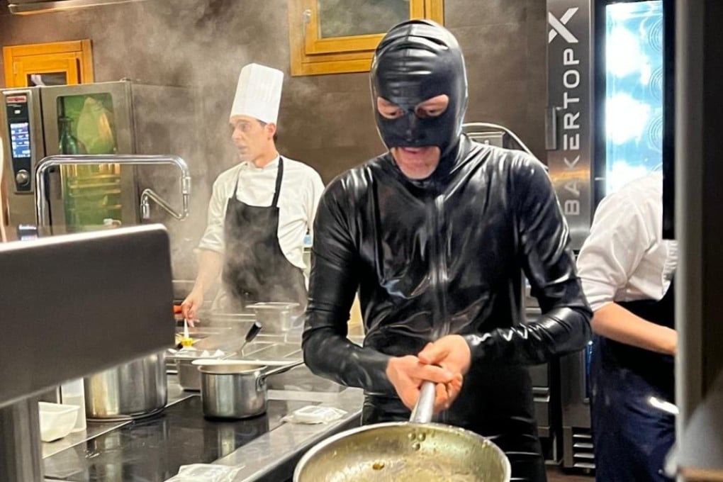 “Latex chef” Giuliano Baldessari, wearing his signature black rubber catsuit, prepares food in the kitchen at Aqua Crua in Barbarano Vicentino, Italy. Photo: Aqua Crua