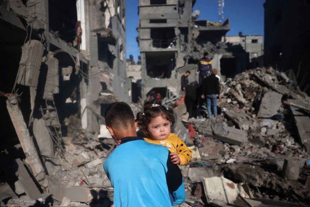 Palestinian children walk through rubble and debris, a result of Israeli strikes, at the Nuseirat refugee camp in the central Gaza Strip last month. Photo: AFP