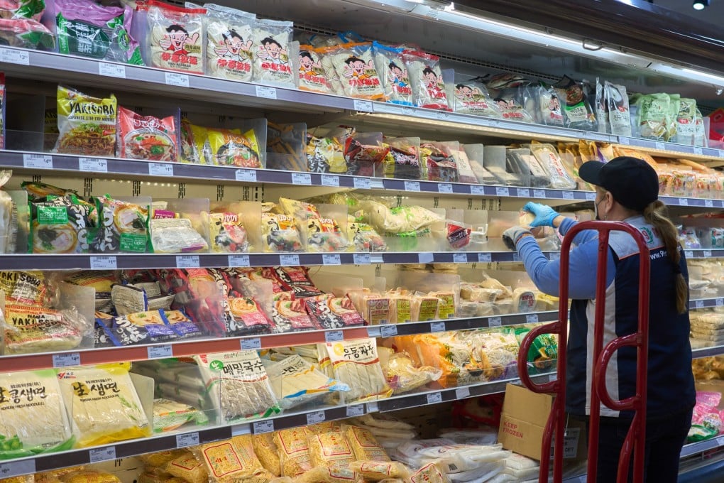 A worker stocks shelves with products imported from China at a market in Los Angeles on April 8. What President Donald Trump wants is to break America’s decades-long dependence on imports. Photo: EPA-EFE