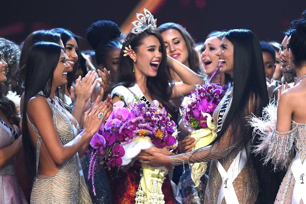 Catriona Gray of the Philippines is congratulated by contestants after winning Miss Universe 2018. We look back at her victory and those of three other Filipino winners of the title, as Netflix premieres A Queen’s Runway about the country’s beauty pageant obsession. Photo: AFP