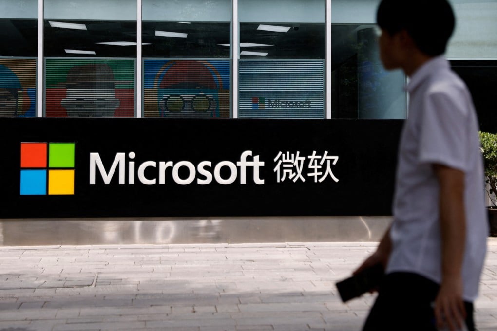 A person walks past a Microsoft sign at its office building in Beijing on May 25, 2023. Photo: Reuters