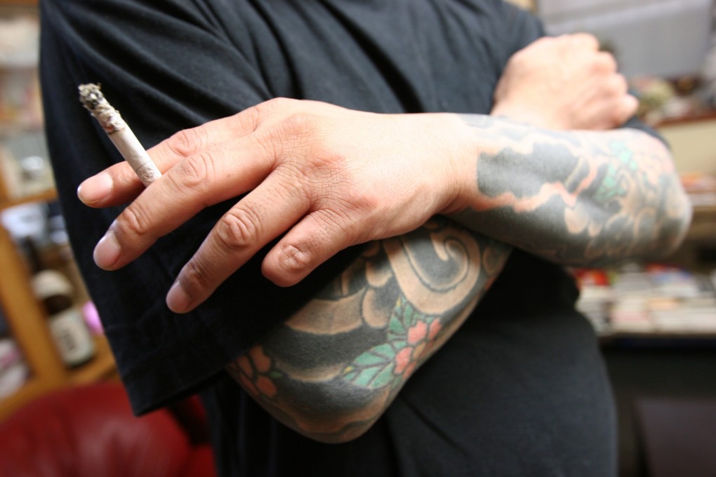 A retired Japanese yakuza crime boss, who does not want to be identified, smokes a cigarette at his residence in Tokyo. Photo: AFP