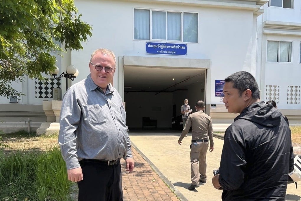 US political science lecturer Paul Chambers, left, of Thailand’s Naresuan University, stands outside the police station in Phitsanulok, Thailand, where he was arrested on Tuesday, April 8, 2025, on charges of insulting the monarchy. Photo: AP