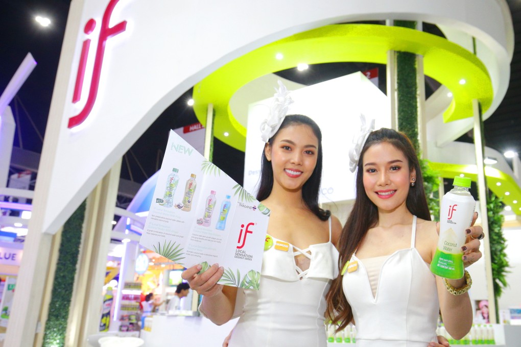 Undated photo of promoters with the If brand of coconut juice, produced by IFBH Limited. Photo: handout