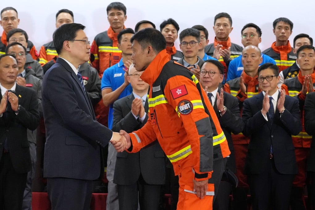Hong Kong leader John Lee meets team members at Hong Kong airport. Photo: May Tse