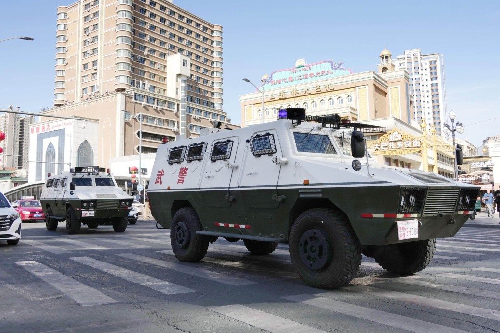Police vehicles patrol near the Grand Bazaar in Urumqi in Xinjiang in July 2024. Photo: Kyodo